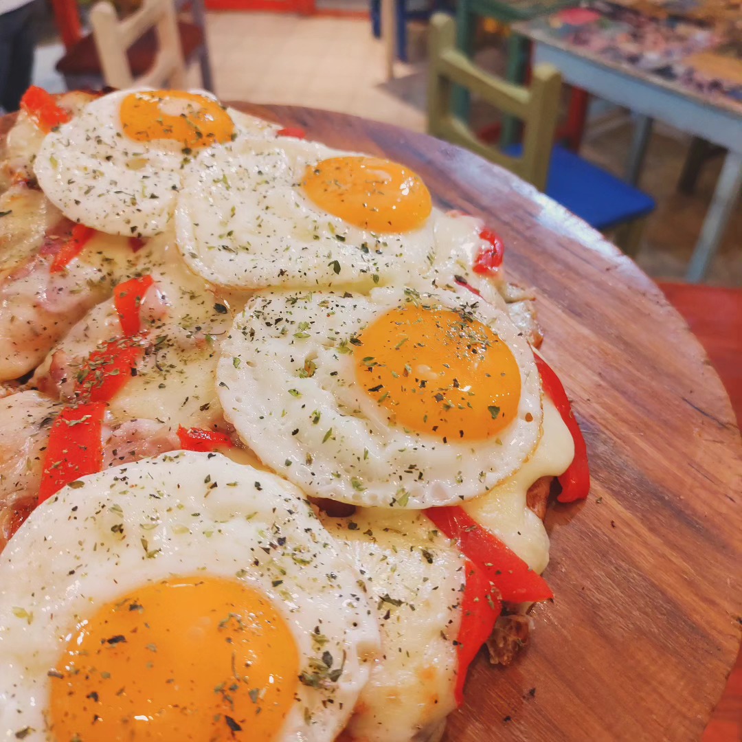 Pizza with fried eggs